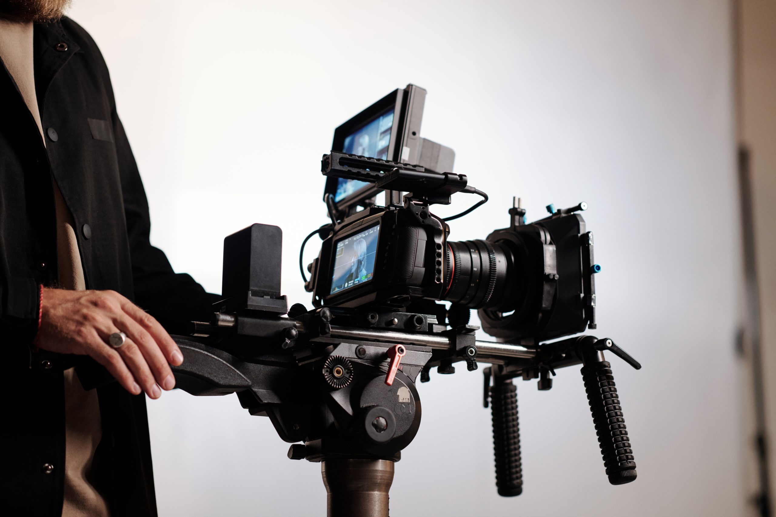 Close up of cameraman or director of shooting team using steadicam